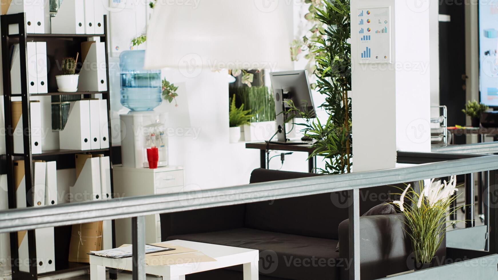 Company department open space with desks, computers at workstations used for business tasks in urban building. Empty startup office with tools and supplies, open floor agency. photo