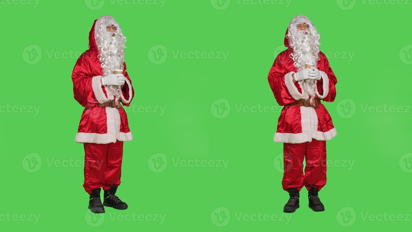 Santa claus drinks cup of hot chocolate in red festive winter costume with had and glasses, enjoying coffee beverage on greenscreen backdrop. Father christmas with seasonal refreshment. photo