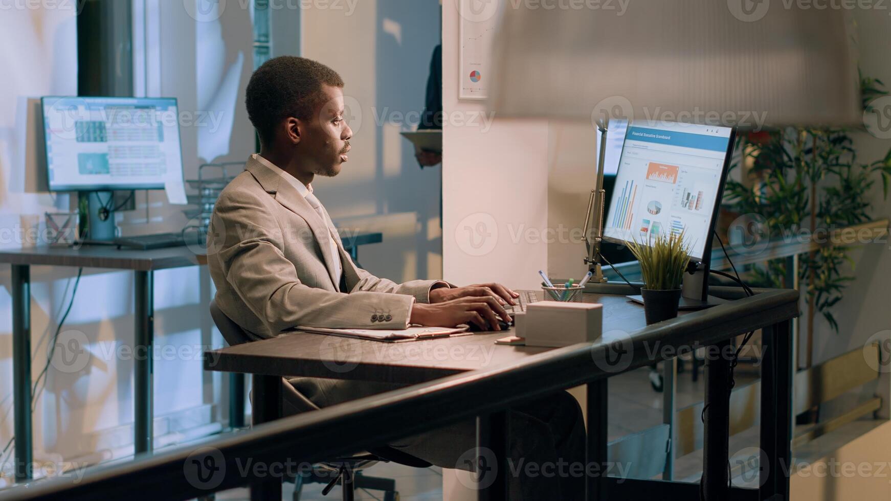 Meticulous bookkeepers verifying documents information on computer for accuracy and completeness during nightshift. Employees working overnight in office, checking company figures photo