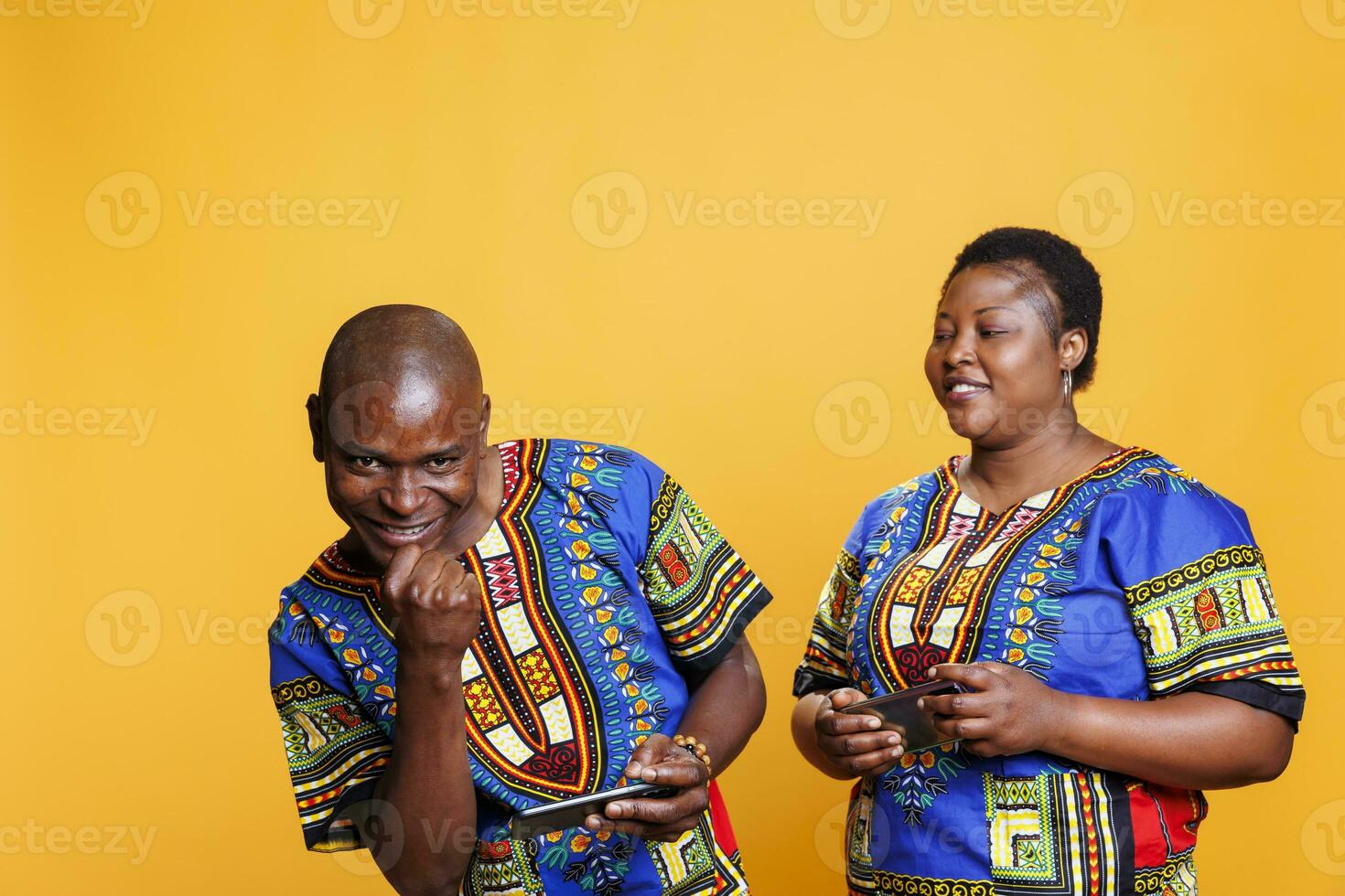 Excited husband winning mobile game competition with wife and showing clenched fist portrait. Happy man playing smartphone videogame with girlfriend, showcasing winner gesture and looking at camera photo