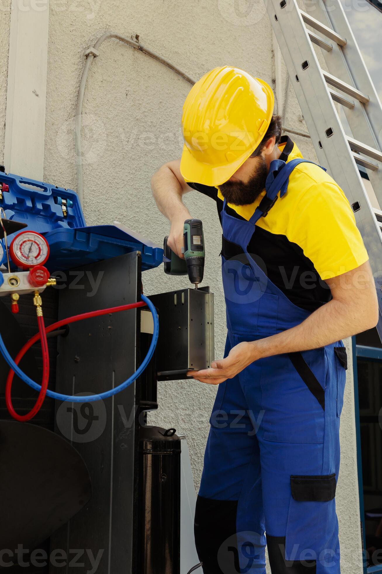 Worker using power tool to fix system electrical issues caused by broken evaporator coil