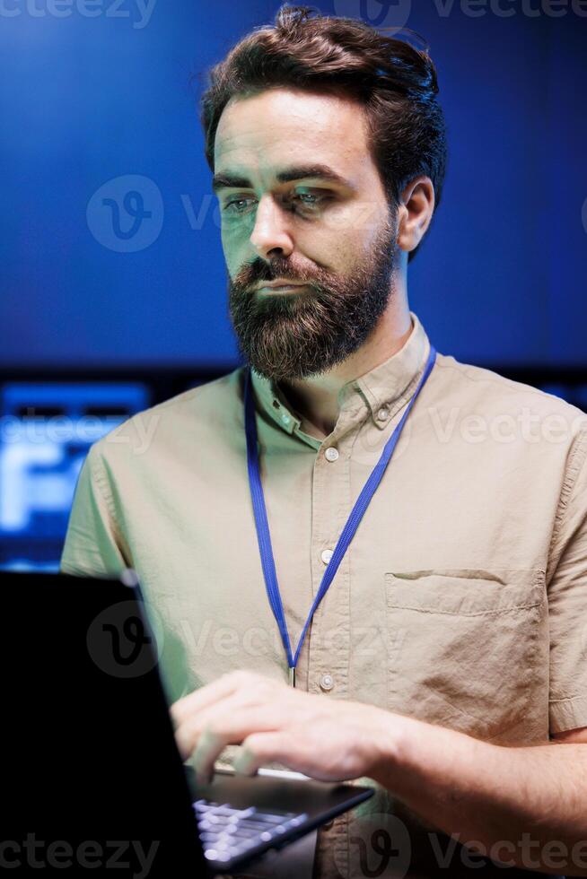 Employee working in server farm providing secure, scalable, and reliable high tech infrastructure for storing, processing, and analyzing large amounts of data generated by AI applications photo