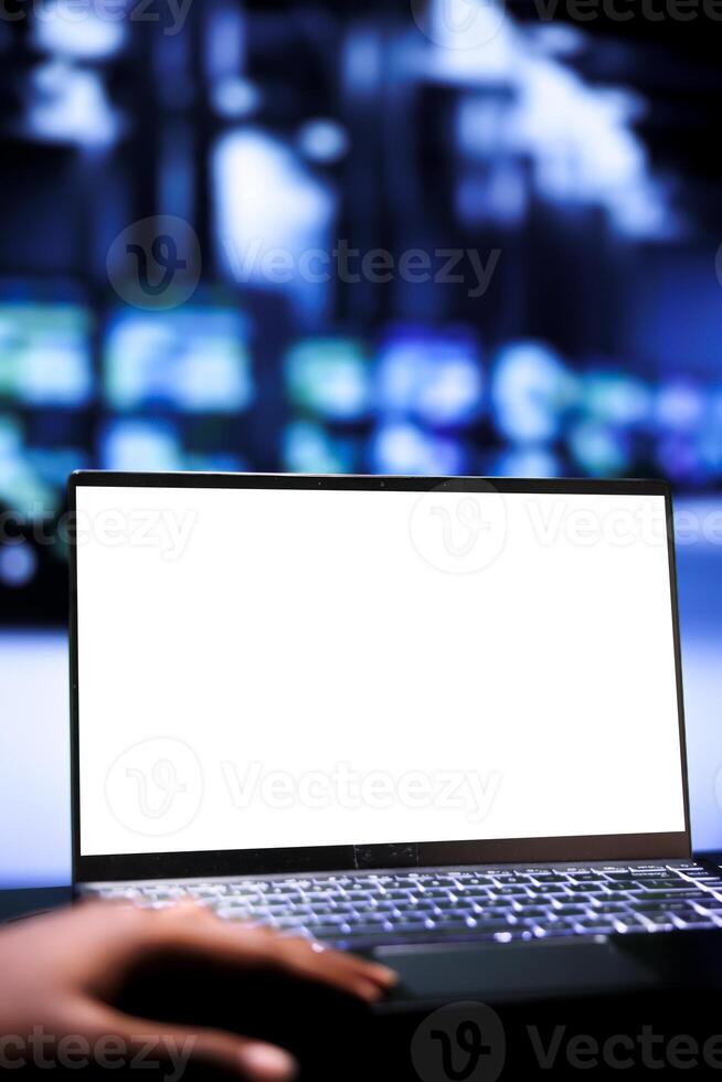 Engineer using mock up laptop to evaluate server racks with high computing power enabling data center to support demanding applications, including virtual reality and video rendering workloads photo