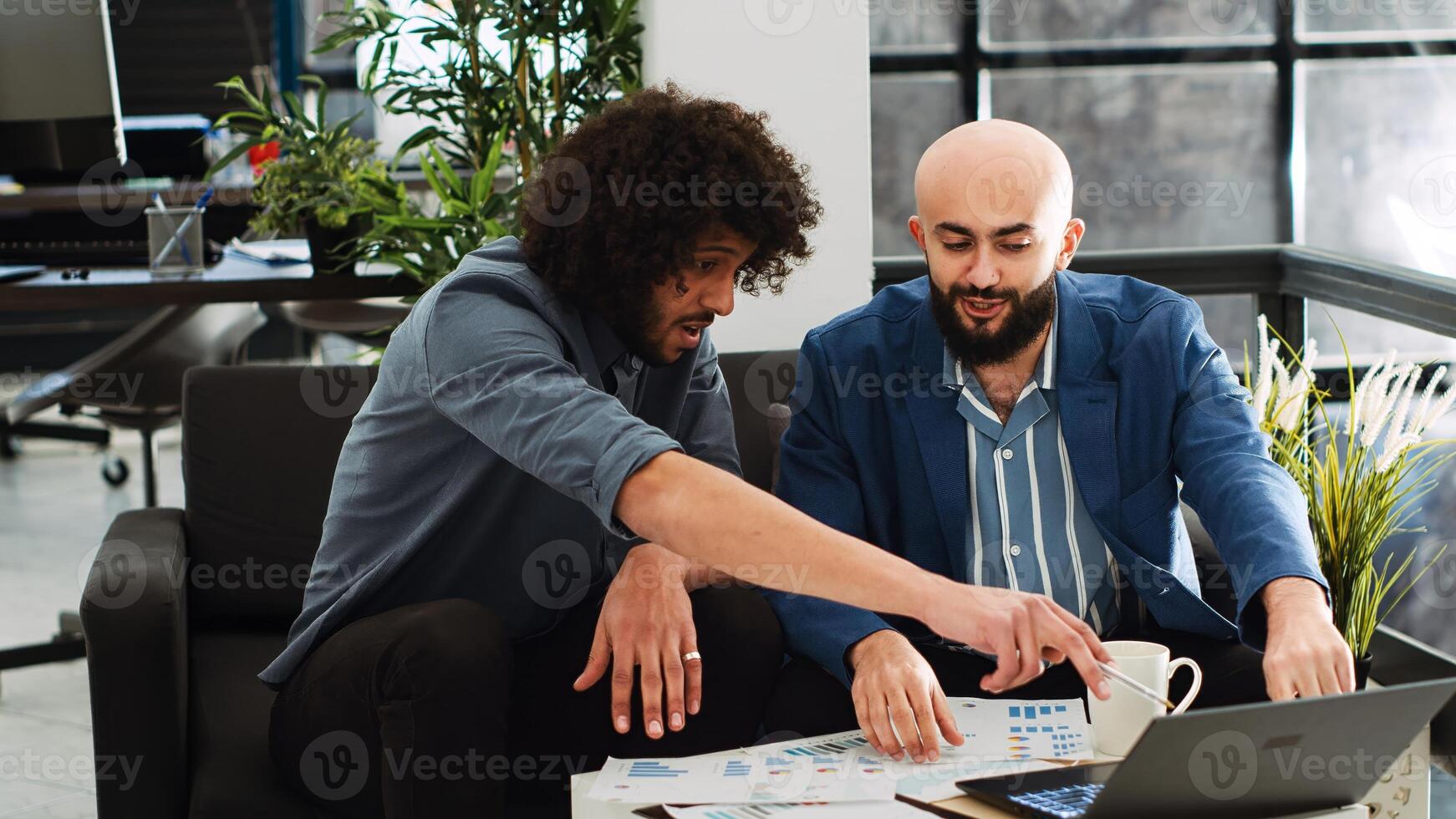 Team of workers plans analytics report, working on business collaboration in open space. Middle eastern colleagues discussing new development strategy and vision in startup office. Tripod shot. photo