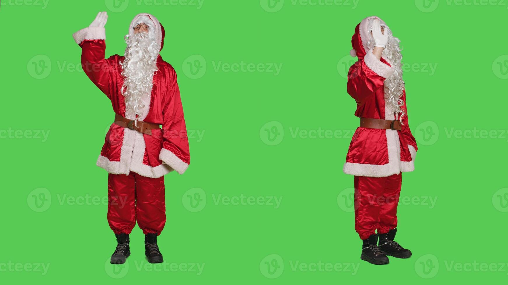 Cheerful character waving hello on camera, greeting people and spreading christmas positivity. Santa claus saying hi while he is wearing iconic red costume with hat and white beard. photo