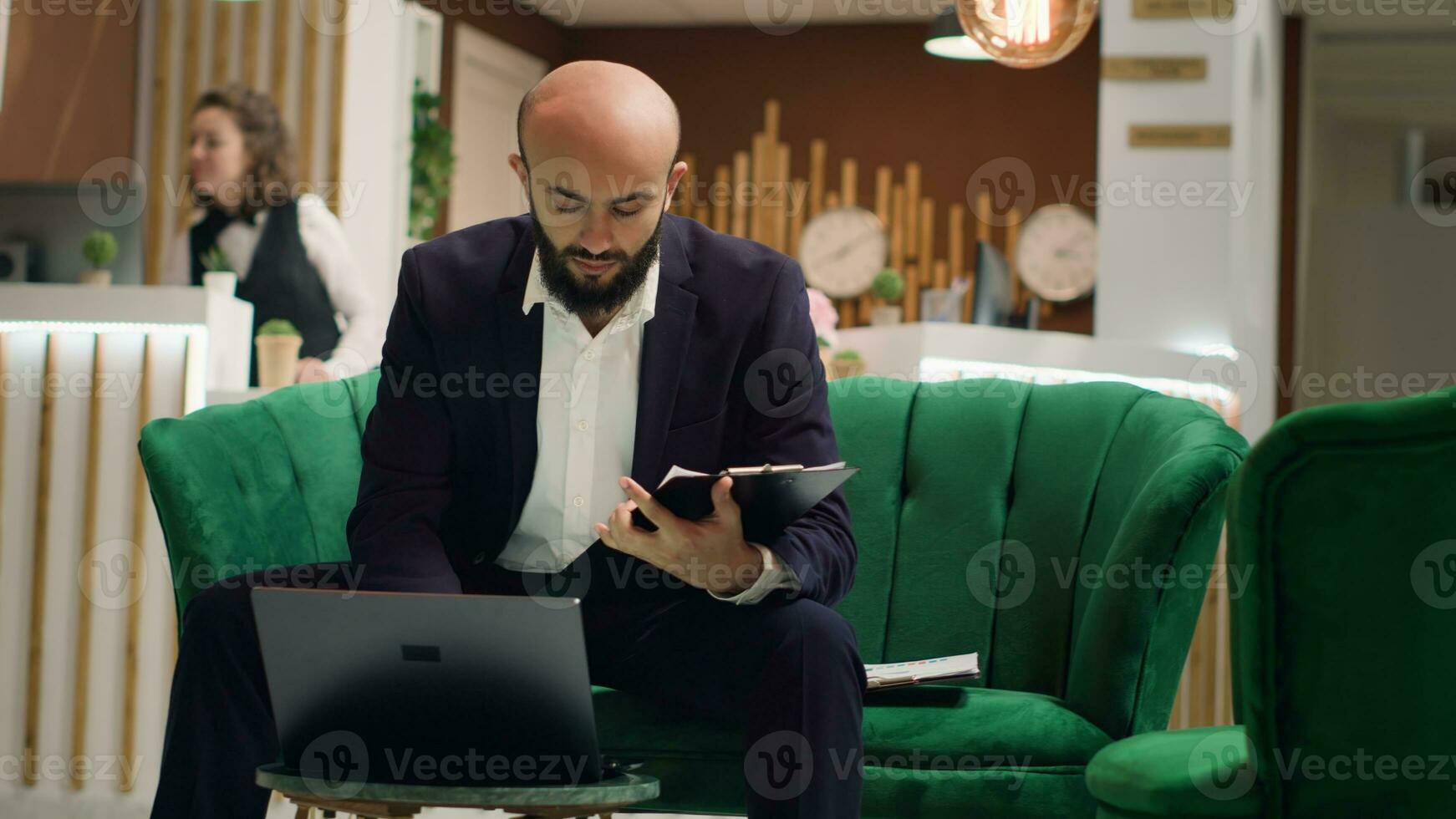 Entrepreneur in suit taking notes to create presentation at business meeting, travelling for event with corporate CEO. Executive manager working to do last minute changes on speech. Handheld shot. photo