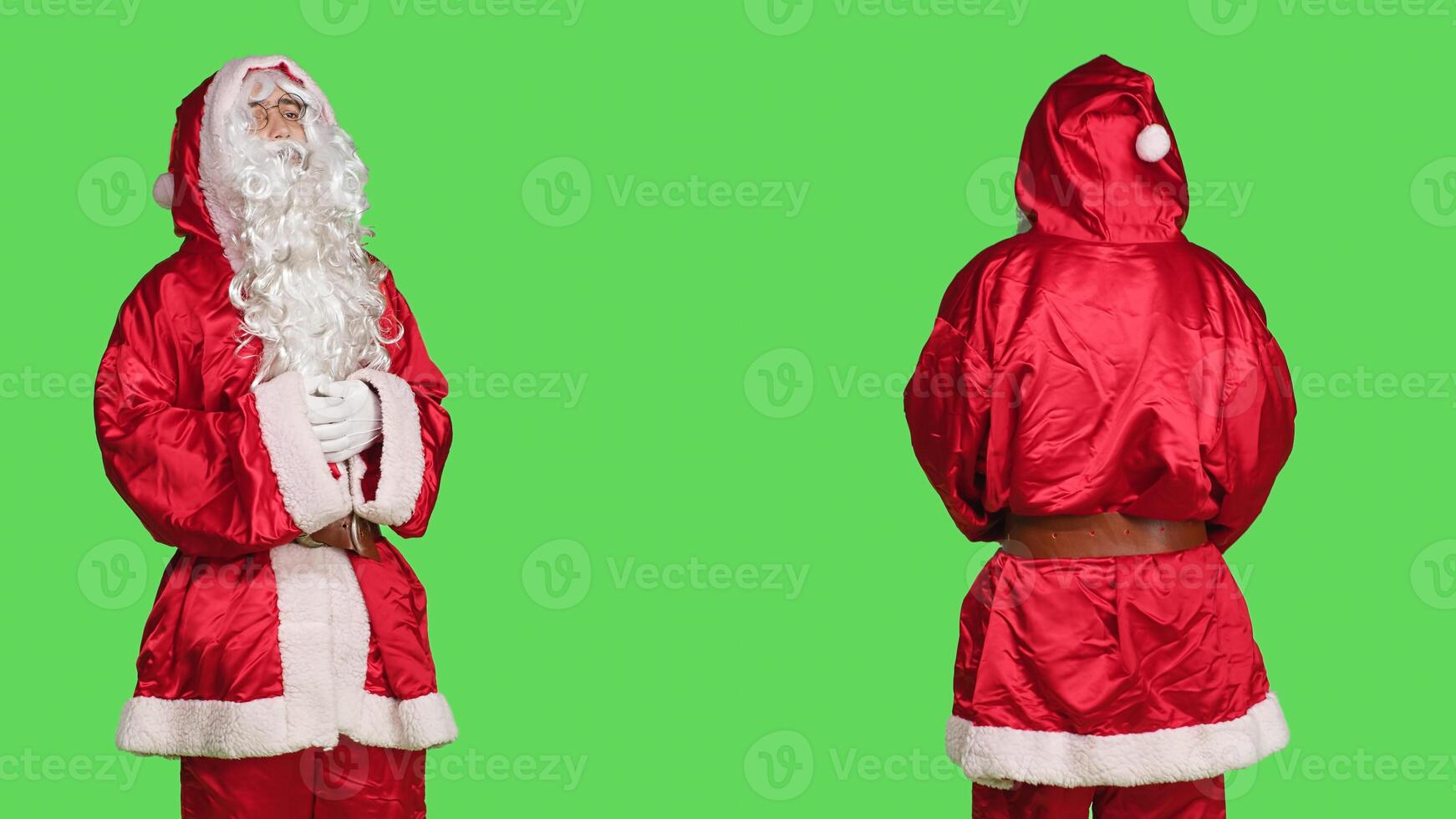 Man portraying santa claus, representing positive and uplifting energy during holiday season. Festive person wearing traditional character costume over greenscreen backdrop, celebration. photo