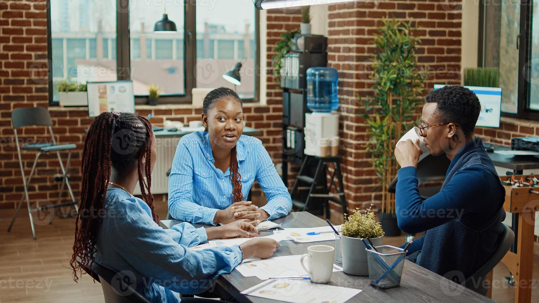 Colleagues working on research project with statistics on papers, discussing about executive analytics plan. Management team examining reports in boardroom meeting, coworking space. photo