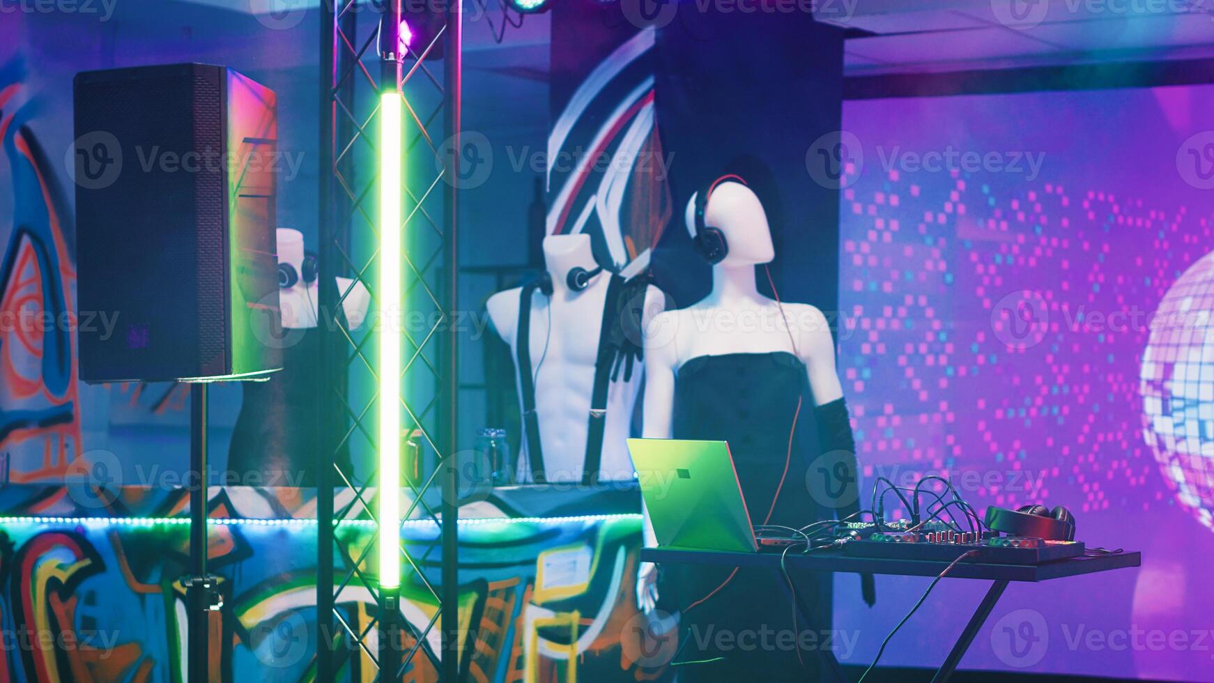 Empty clubbing stage with DJ station used for live eletronic music at party on dance floor. Nightclub with disco lights and audio mixing equipment, discotheque and bar used for event. photo