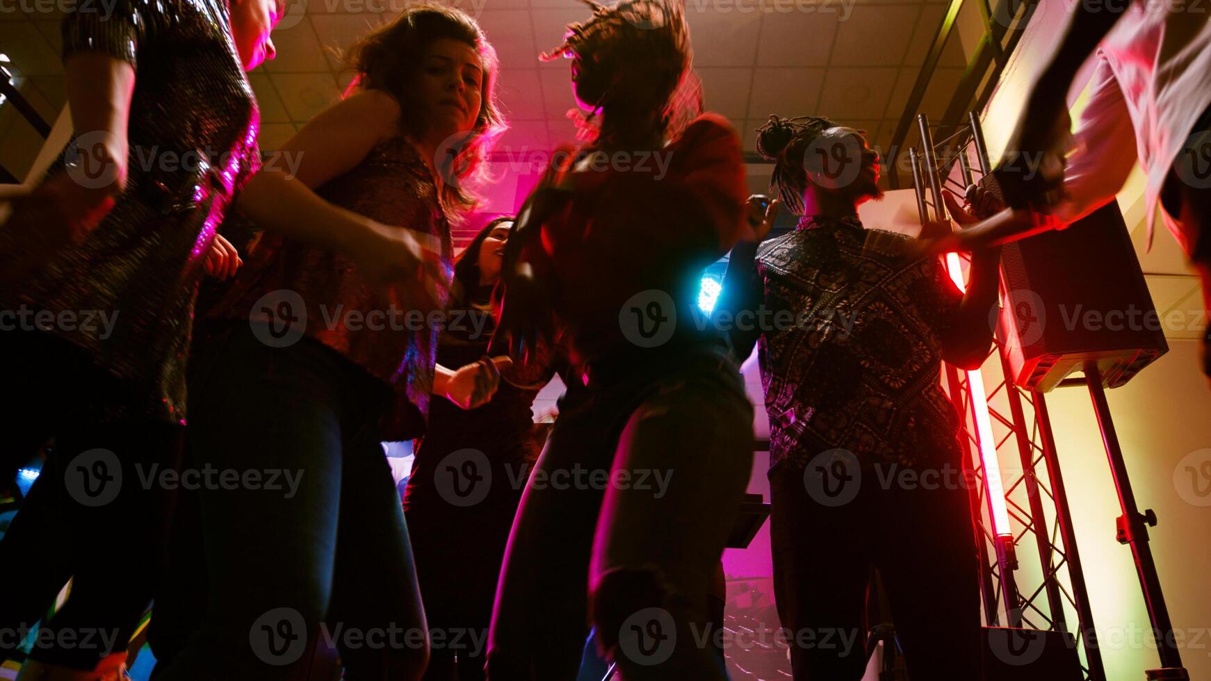 pov de amigos bailando a disco fiesta, disfrutando social reunión con moderno clubbing música en danza piso. grupo de personas teniendo divertido juntos a danza evento en discoteca. Mano disparo. foto