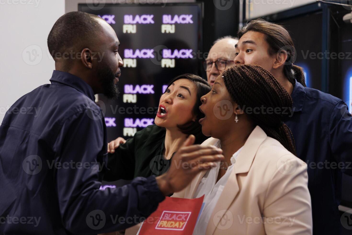 Mad angry diverse people shoppers eager to start Black Friday shopping, arguing with security guy, asking him to open store. Customers tired of waiting in line during seasonal sales photo