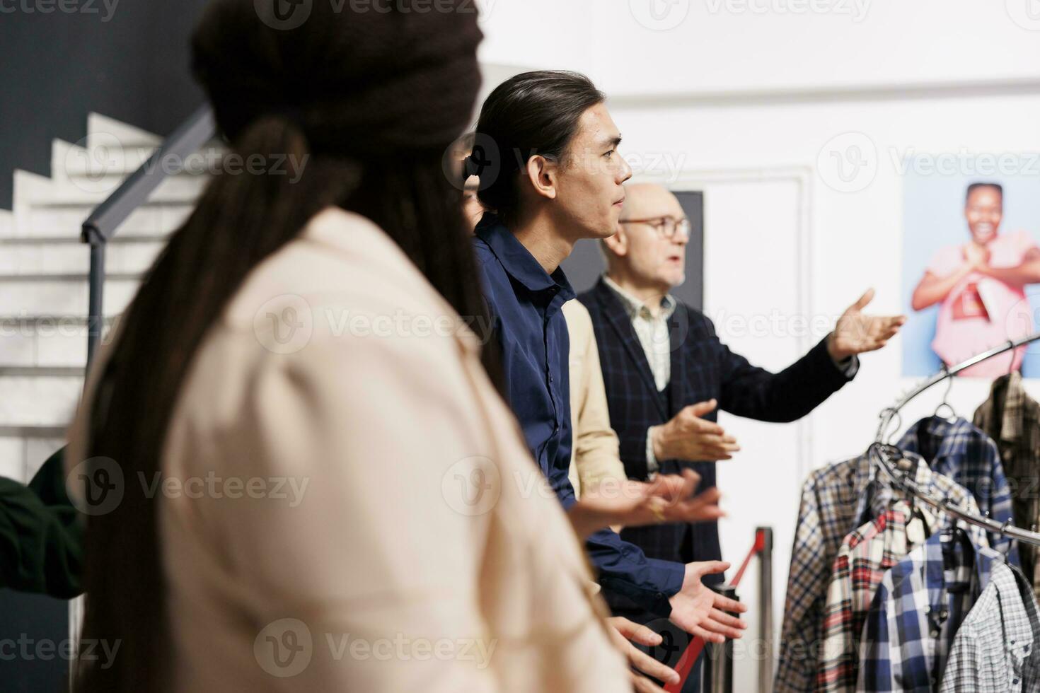 Diverse people customers arguing with clothing store staff while waiting in line for sales. Angry anxious crowd wait when Black Friday special offers start, standing at shopping mall entrance photo