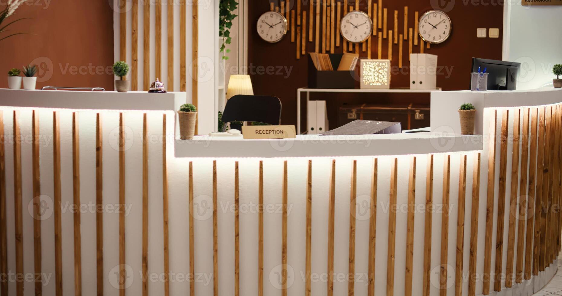 Rack focus shot of stylish travel vacation accommodation lounge interior with posh green furniture ready to welcome guests. Empty luxury hotel foyer with check in reception front desk photo