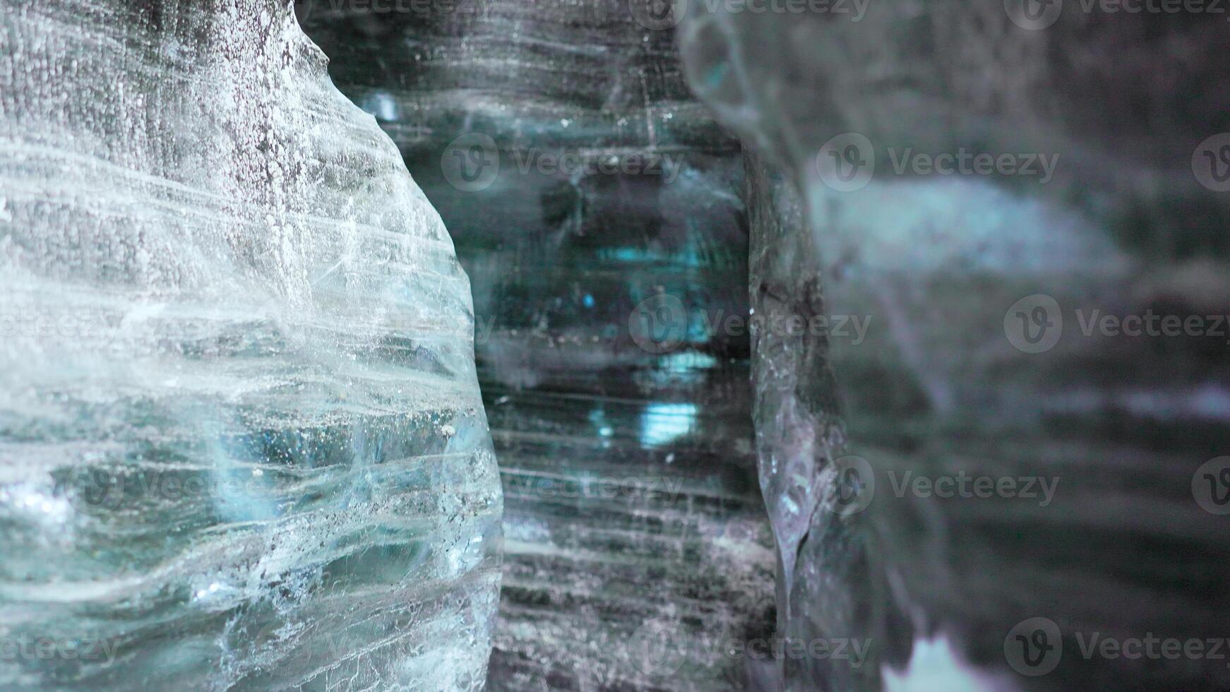 Inside crevasse in vatnajokull polar cap with cracked ice blocks structure, covered frost landscape. Massive transparent glacier in wintry icelandic scenery, icy frosty rocks. Handheld shot. photo