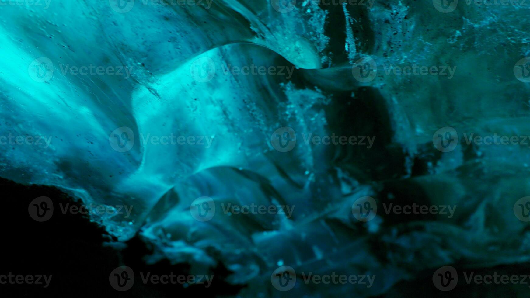 Vatnajokull glacier hiking in crevasse, nordic landscape inside ice cave with blue ice rocks. Frosty polar icebergs with cracked frozen structure, icelandic freezing cold destination . Handheld shot. photo