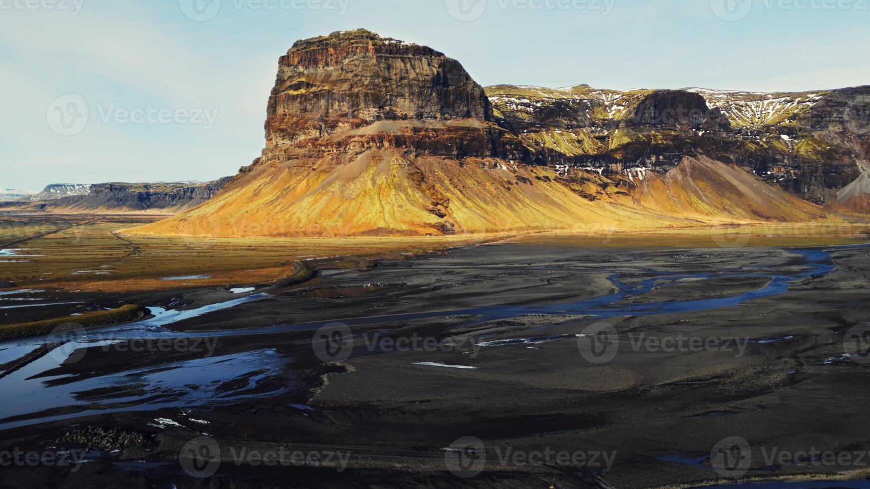 Drone shot of huge mountain chain on icelandic scenery, spectacular nordic nature on roadside. Massive hills and snowy grounds in iceland, scandinavian landscape scenic route. Slow motion. photo