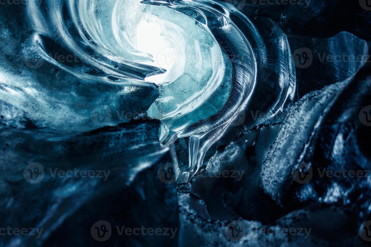 Huge rocks of ice inside vatnajokull glacier crevasse in icelandic landscapes, majestic transparent frozen icy blocks. Ice caves with frosty textured stones covered in frost, glacier hiking. photo