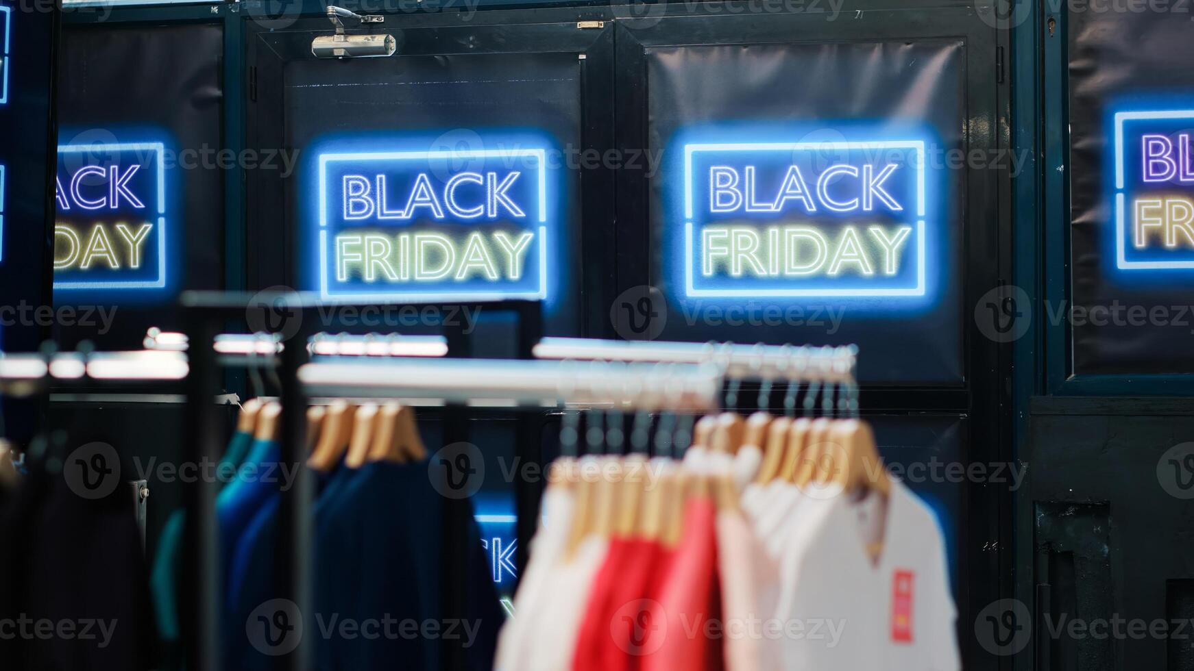 Empty fashion department store with sales and discounted items, retail shop with clothes on hangers. Black friday advertisement during november seasonal promotions, special offers sign. photo