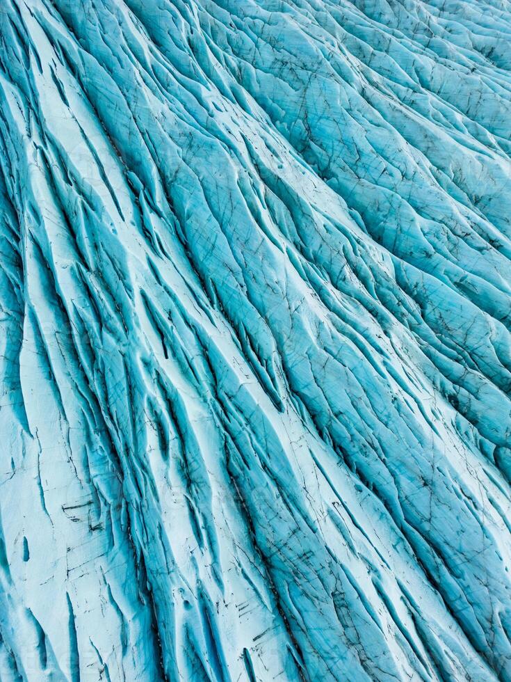 Drone shot of polar icebergs with gorgeous blue ice blocks within icelandic landscape, covered in frost. Fantastic arctic scenery of vatnajokull glacier in iceland, glacier lagoon. photo