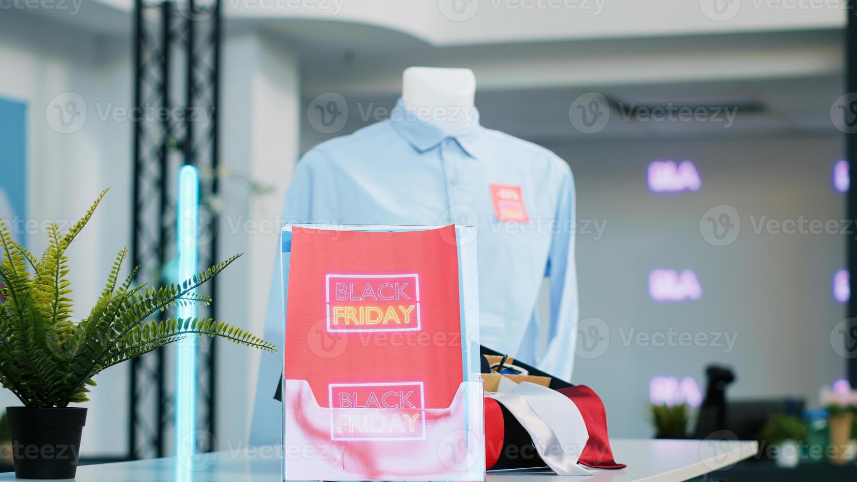 Clothes at promotional prices in retail store, black friday big sales and discounts in shop at mall. Empty boutique filled with seasonal sale labels and special offers, holiday shopping event. photo