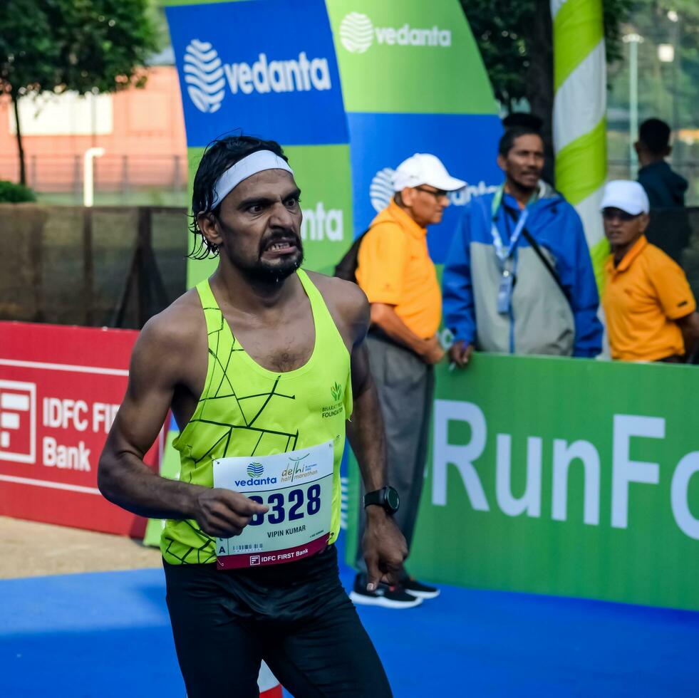 New Delhi, India - July 16 2023 - Vedanta Delhi Half Marathon race after covid in which marathon participants about to cross the finish line, Delhi Half Marathon 2022 photo