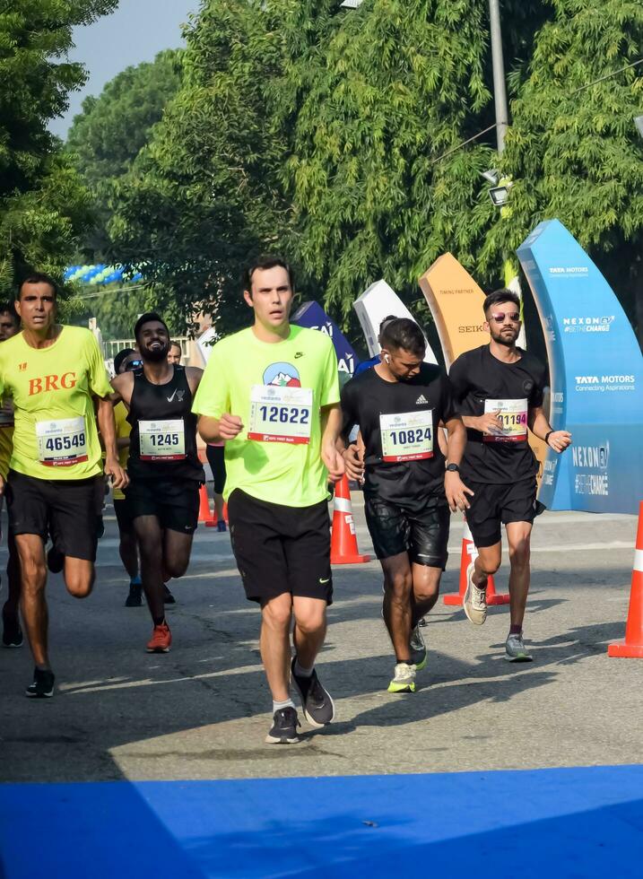 New Delhi, India - July 16 2023 - Vedanta Delhi Half Marathon race after covid in which marathon participants about to cross the finish line, Delhi Half Marathon 2022 photo