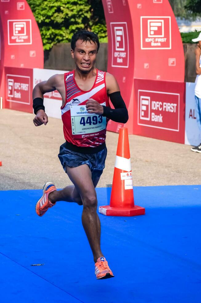 New Delhi, India - July 16 2023 - Vedanta Delhi Half Marathon race after covid in which marathon participants about to cross the finish line, Delhi Half Marathon 2022 photo