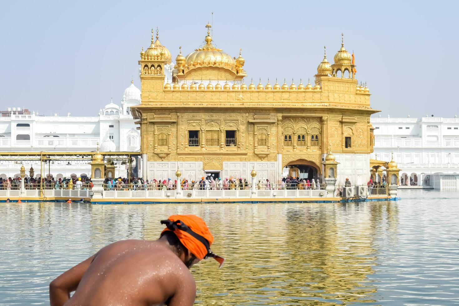 Amritsar, India - February 26 2023 - Unidentified devotees taking holy dip in sarovar at Golden Temple - Harmandir Sahib in Amritsar, Punjab, India, Famous indian sikh landmark, Golden Temple photo