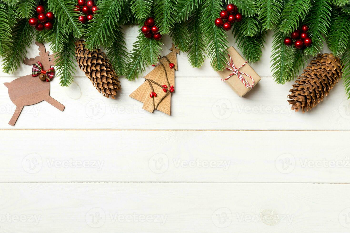 Top view of fir tree and New Year decorations on wooden background. Christmas concept with copy space photo