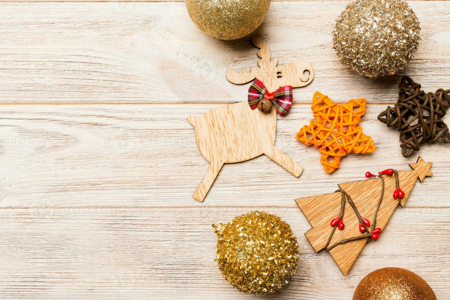 Winter set made of Christmas balls and various decorations on holiday wooden background. Top view of New Year concept with copy space photo