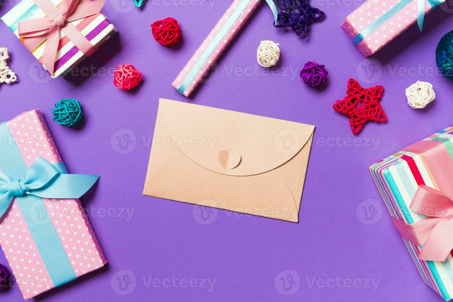 Top view of envelope on purple background. New Year decorations. Christmas holiday concept photo