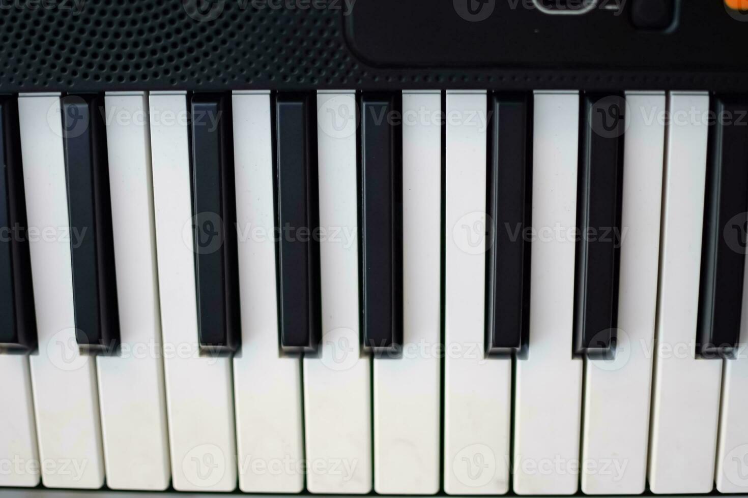 Close-up of piano keys. Piano black and white keys and Piano keyboard musical instrument placed at the home balcony during sunny day. photo