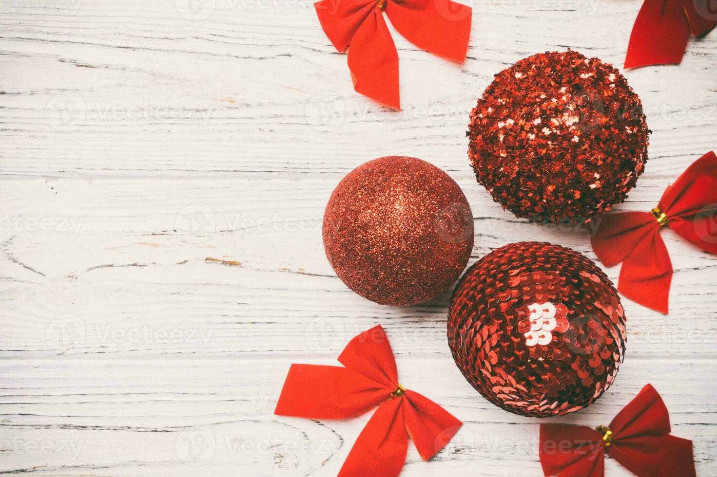 Creative set of New Year baubles and decorations on wooden background. Top view of Christmas time concept. Copy space photo