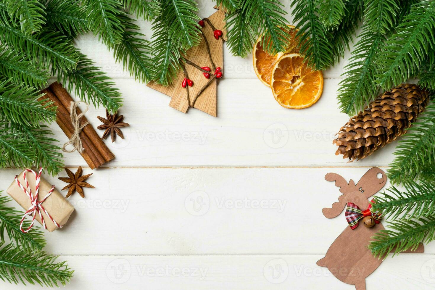 Top view of fir tree branches and festive decorative toys on wooden background. New Year time concept with empty space for your design photo