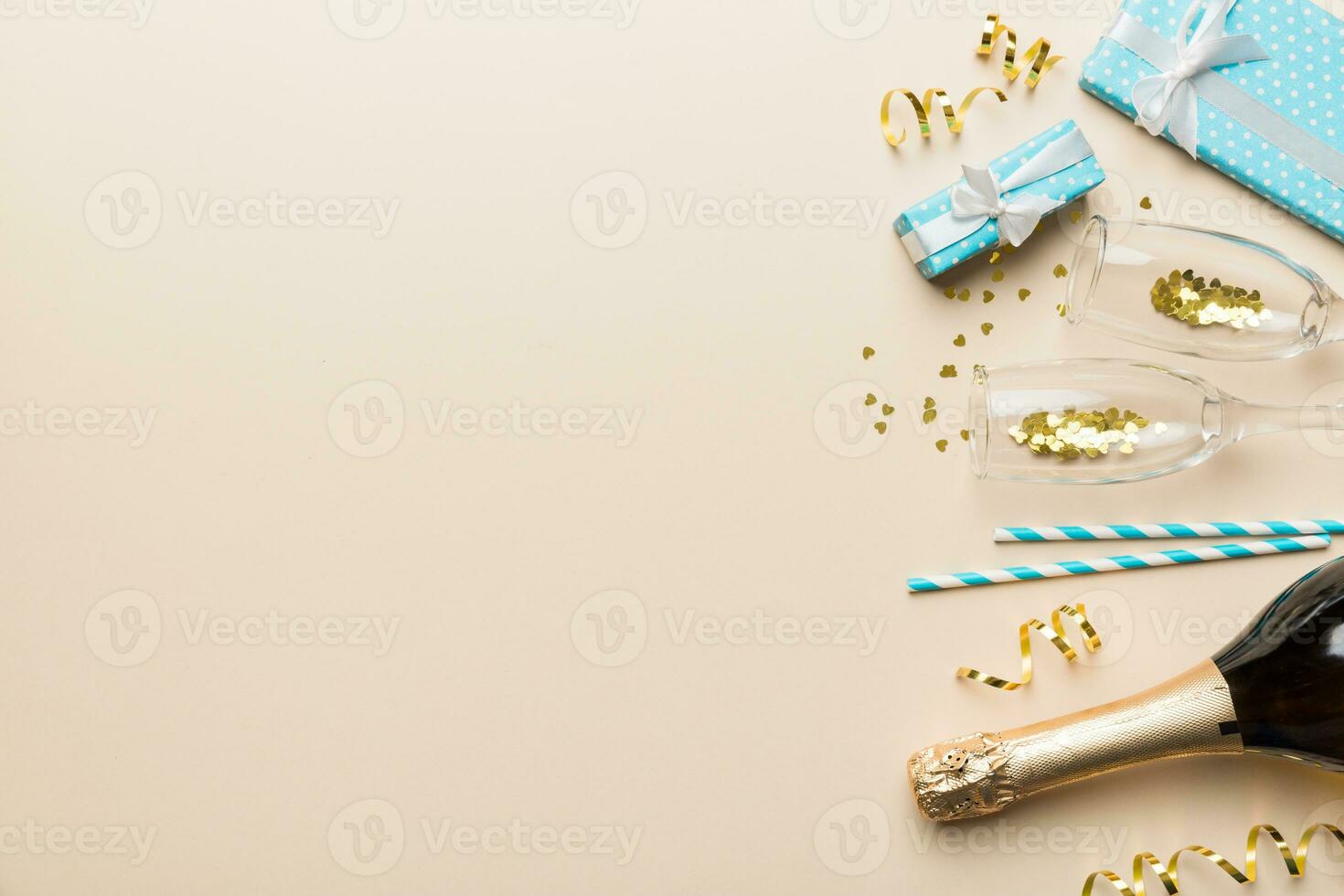 Bottle of champagne with colored glitter, confetti and gift box space for text on colorfull background, top view. Hilarious, christmas and birthday celebration photo