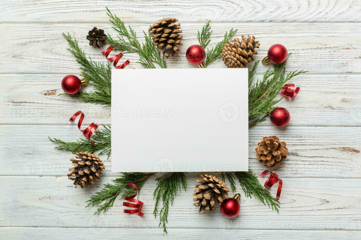 Flat lay Christmas composition. square Paper blank, pine tree branches, christmas decorations on Colored background. Top view, copy space for text photo