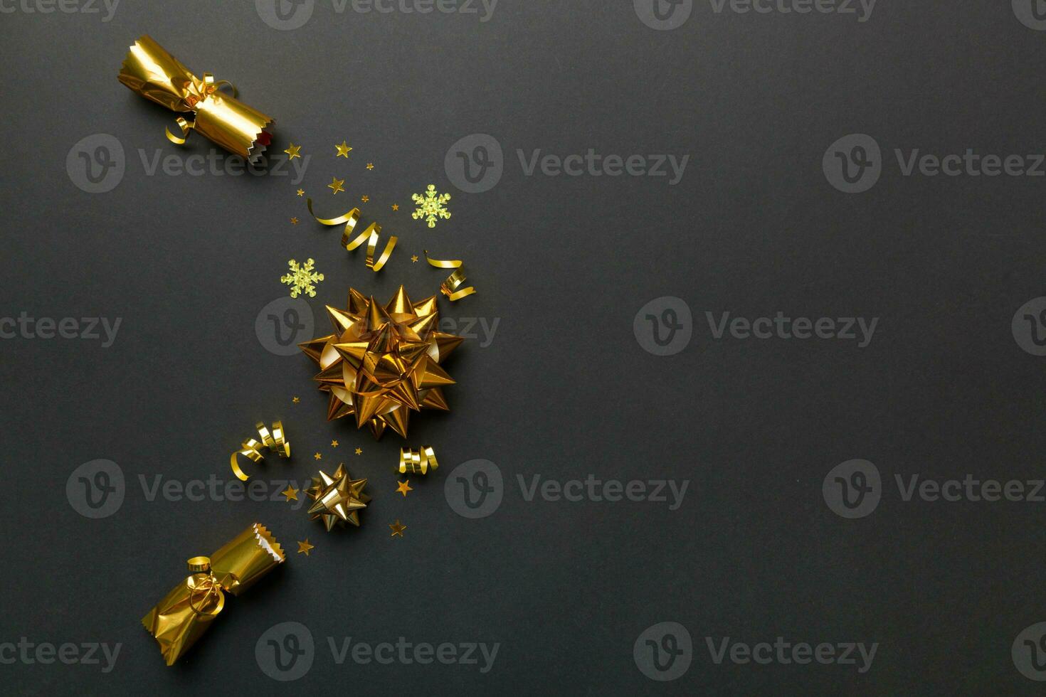 Christmas crackers with shiny confetti on color background, top view, copy space photo