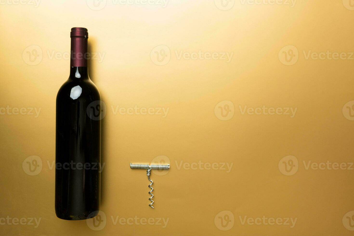 One Bottle of red wine on colored table. Flat lay, top view wth copy space photo