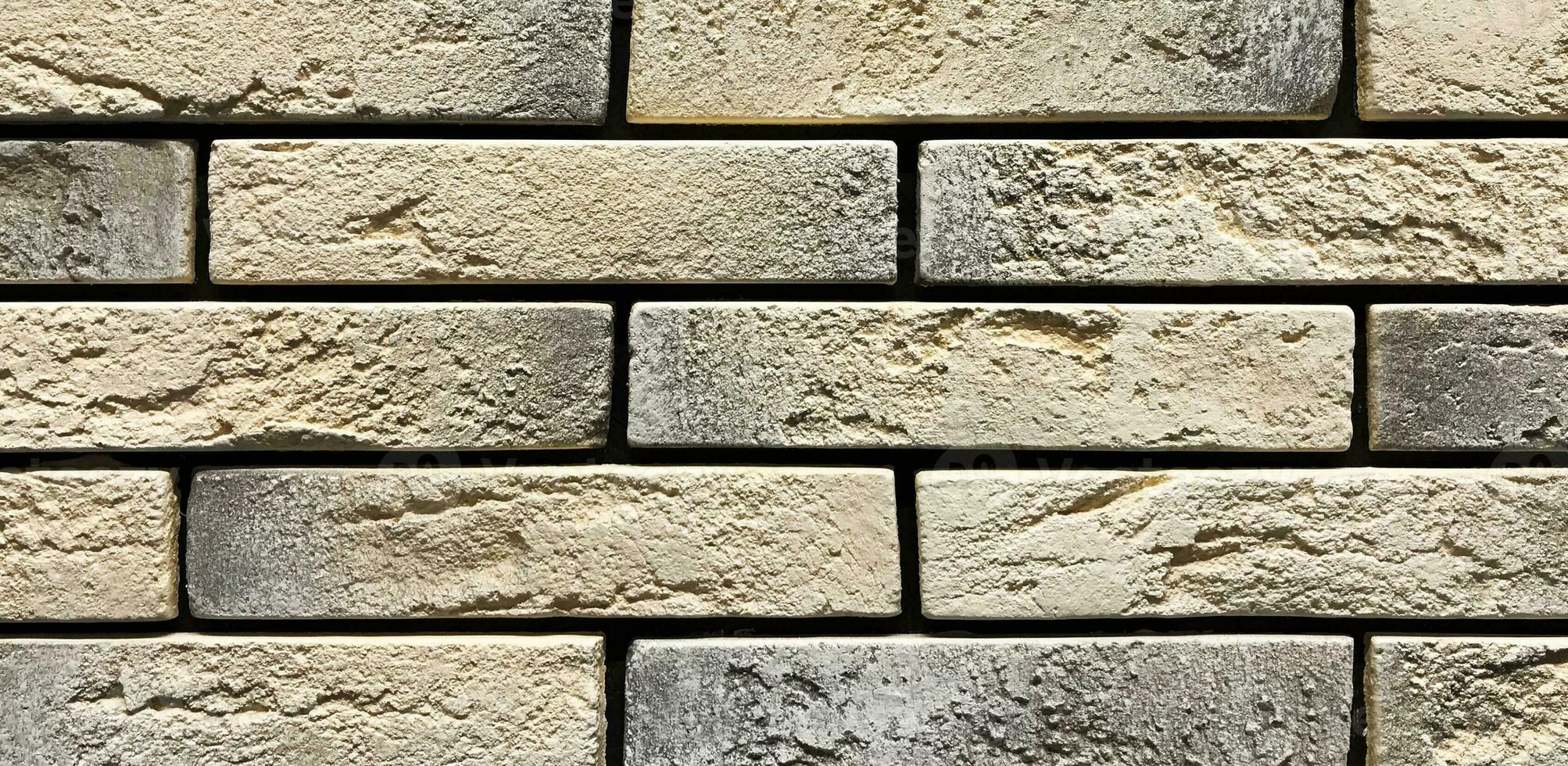 Old orange vintage wall made of craft stones photo