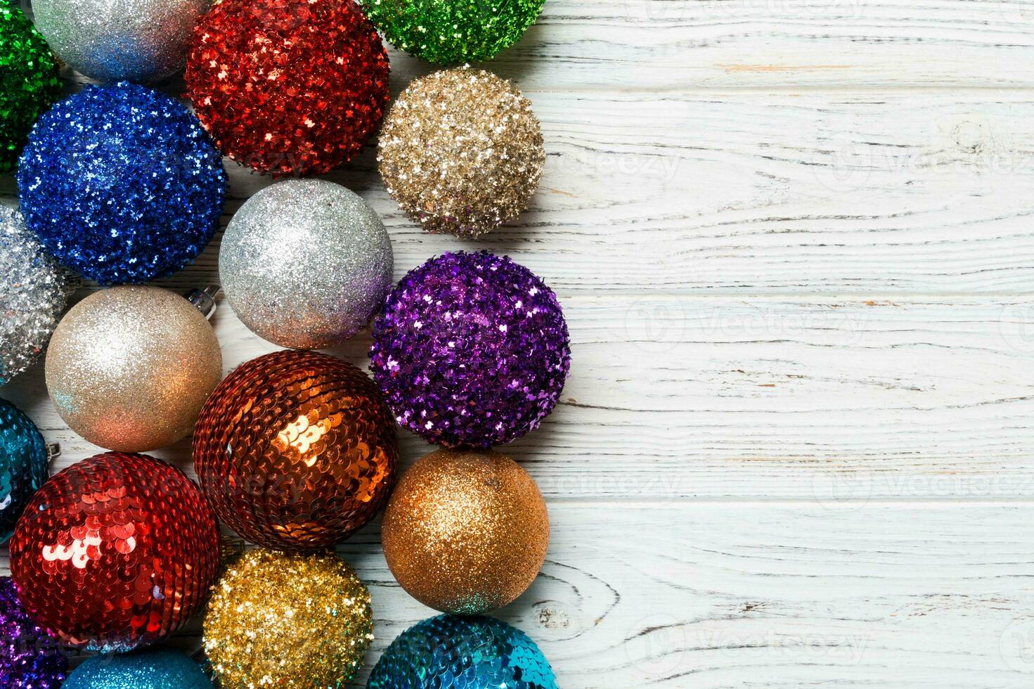 Festive composition of decorative baubles on wooden background. Top view of Christmas toys with copy space photo