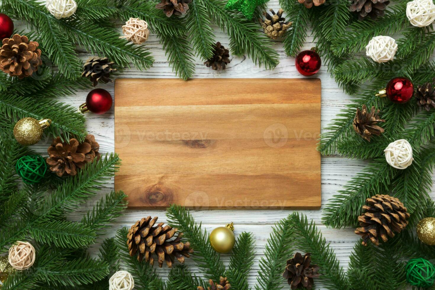 Festive table decoration with New Year branches and dekor an empty plate. Top view with space for text. Christmas time photo