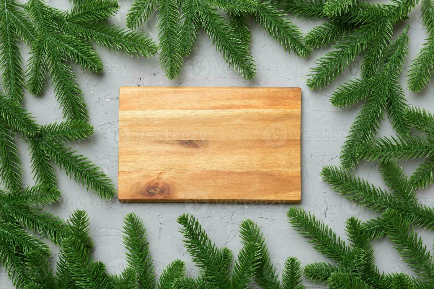 Festive table decoration with New Year branches and an empty plate. Top view with space for text. Christmas time photo