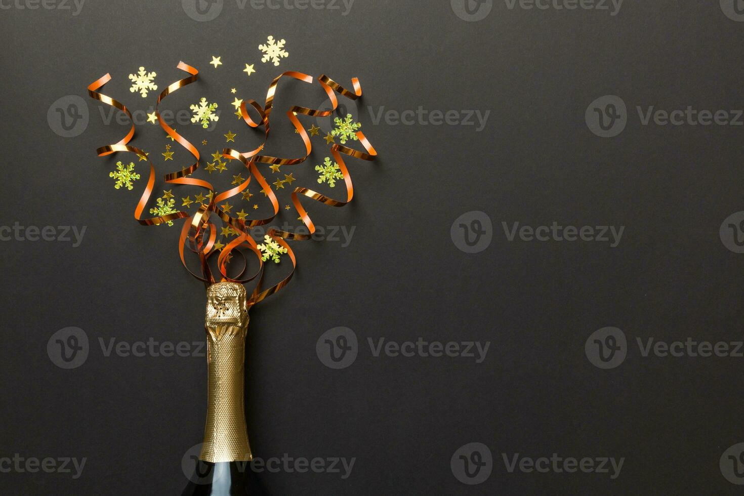 Creative flat lay composition with bottle of champagne and space for text on color background. Champagne bottle with colorful party streamers. holiday or christmas concept photo