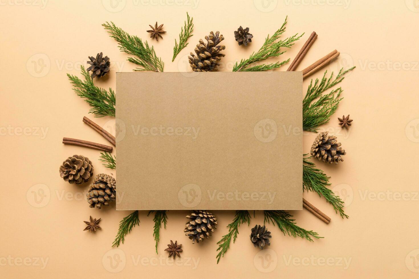 Flat lay Christmas composition. square Paper blank, pine tree branches, christmas decorations on Colored background. Top view, copy space for text photo