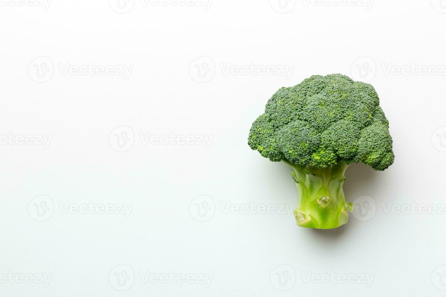 Top view fresh green broccoli vegetable on Colored background. Broccoli cabbage head Healthy or vegetarian food concept. Flat lay. Copy space photo