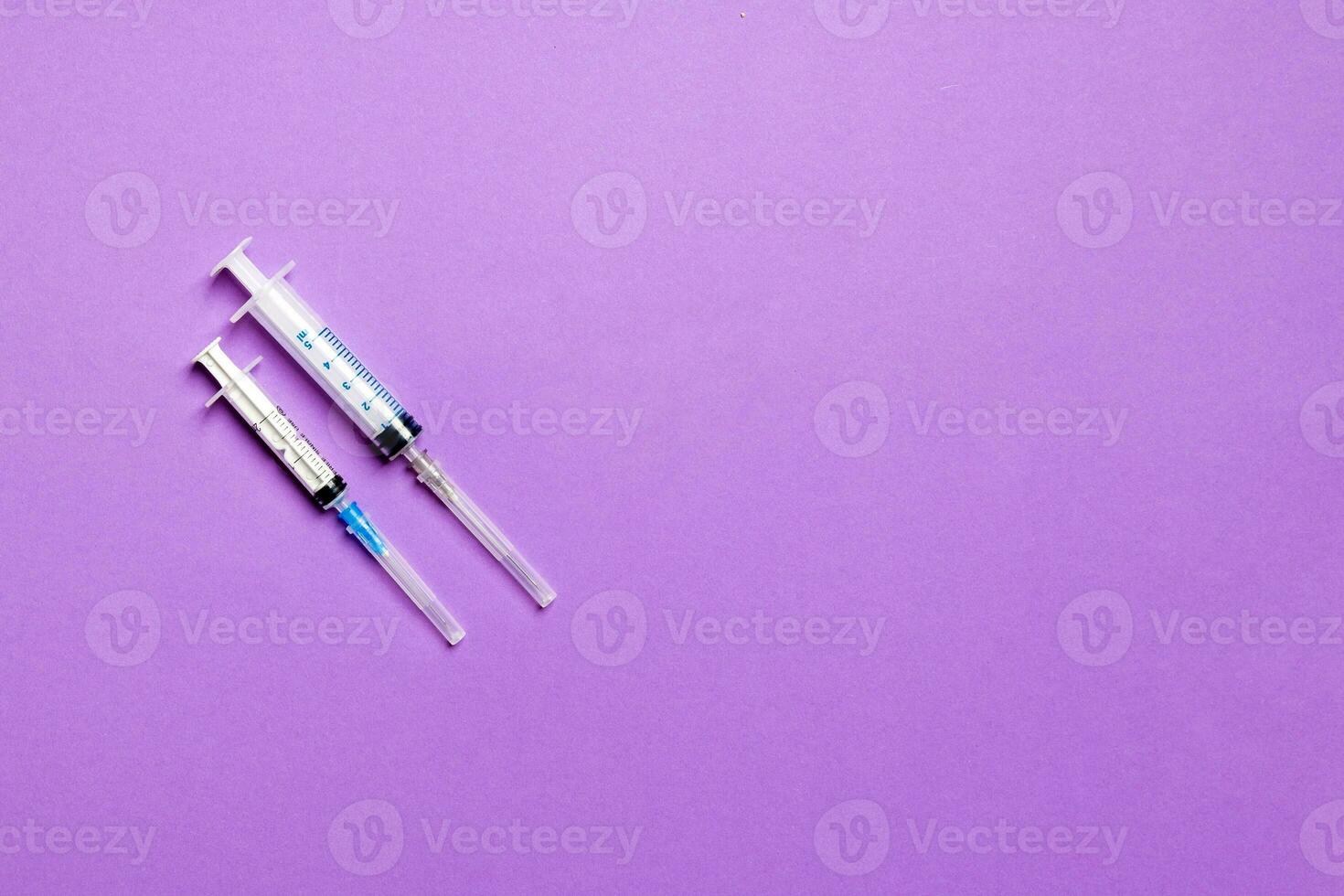 Top view of different syringes for injection on colorful background. Medical equipment concept with copy space photo