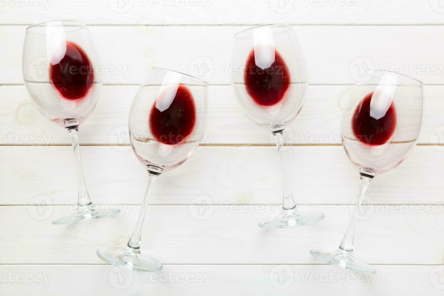 Many glasses of red wine at wine tasting. Concept of red wine on colored background. Top view, flat lay design photo