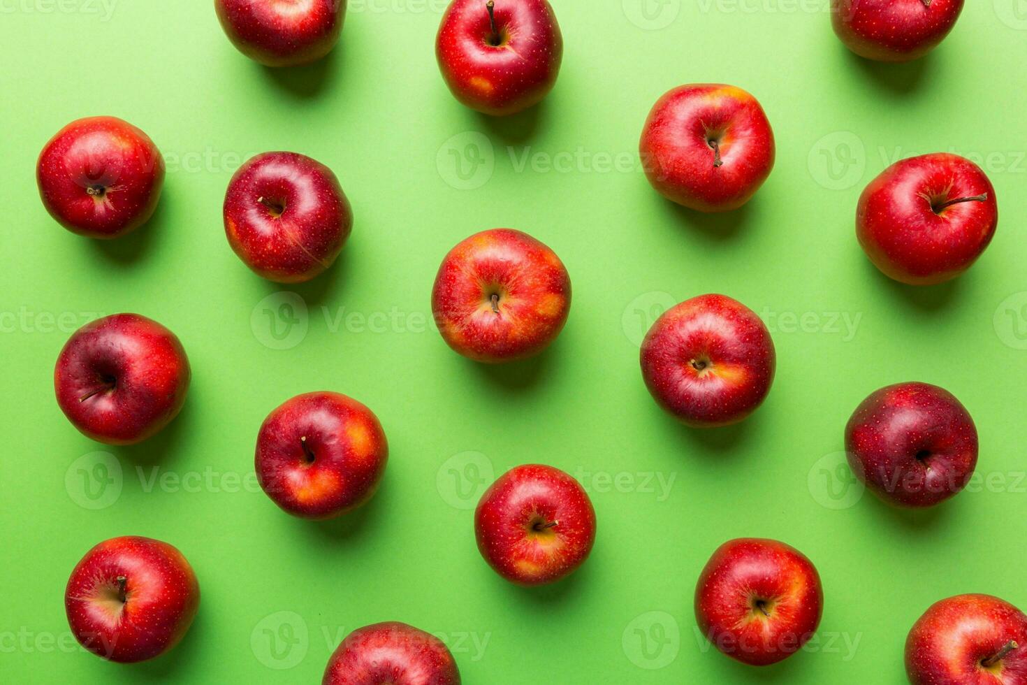 Many red apples on colored background, top view. Autumn pattern with fresh apple above view photo