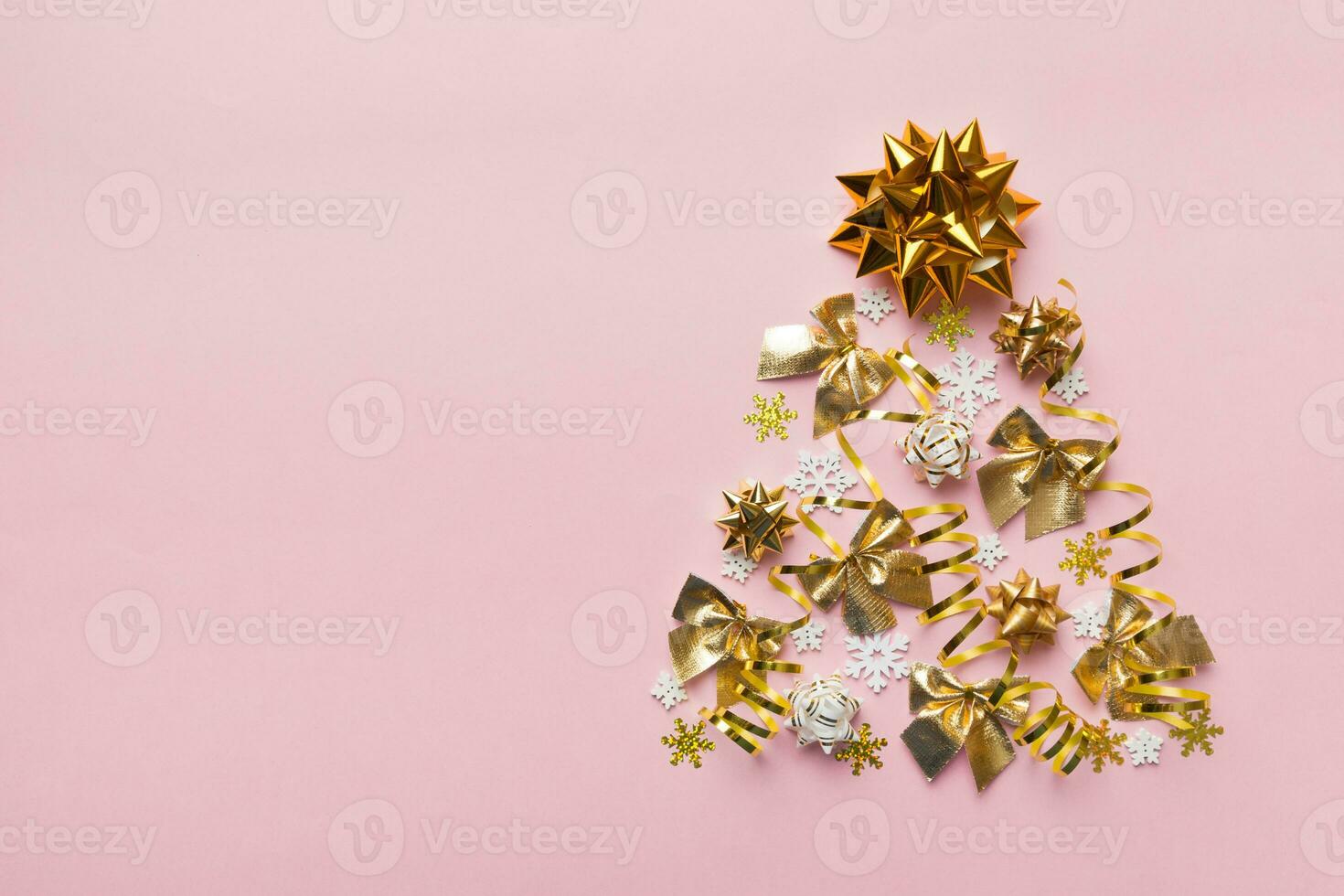 Christmas tree made from colored ball decoration on colored background, view from above. New Year minimal concept with copy space photo