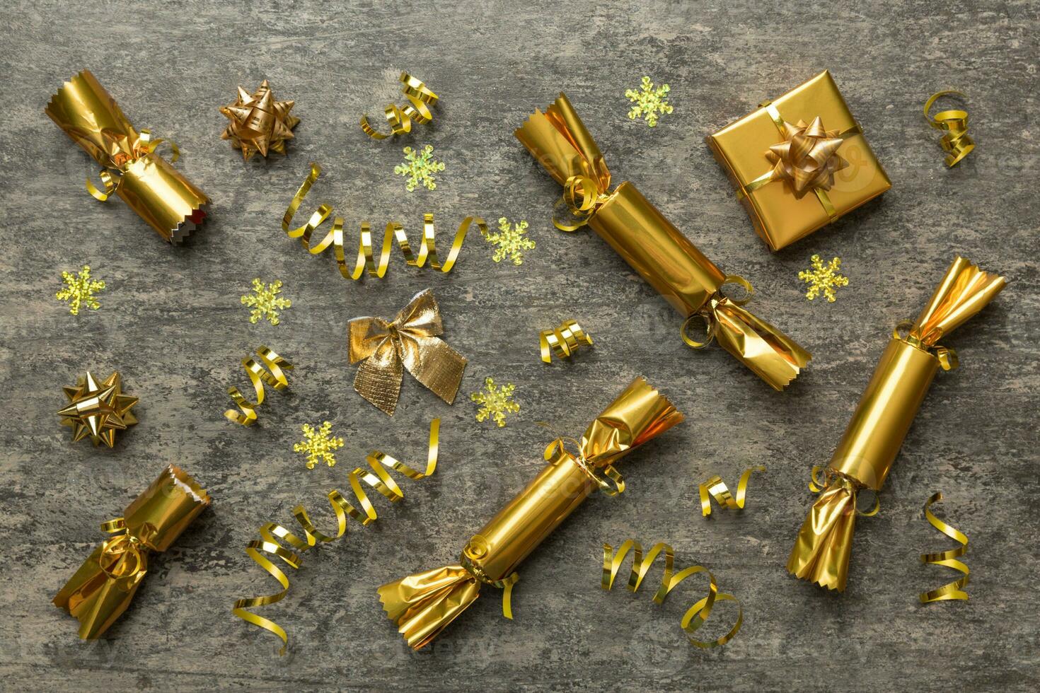 Christmas crackers with shiny confetti on color background, top view, copy space photo